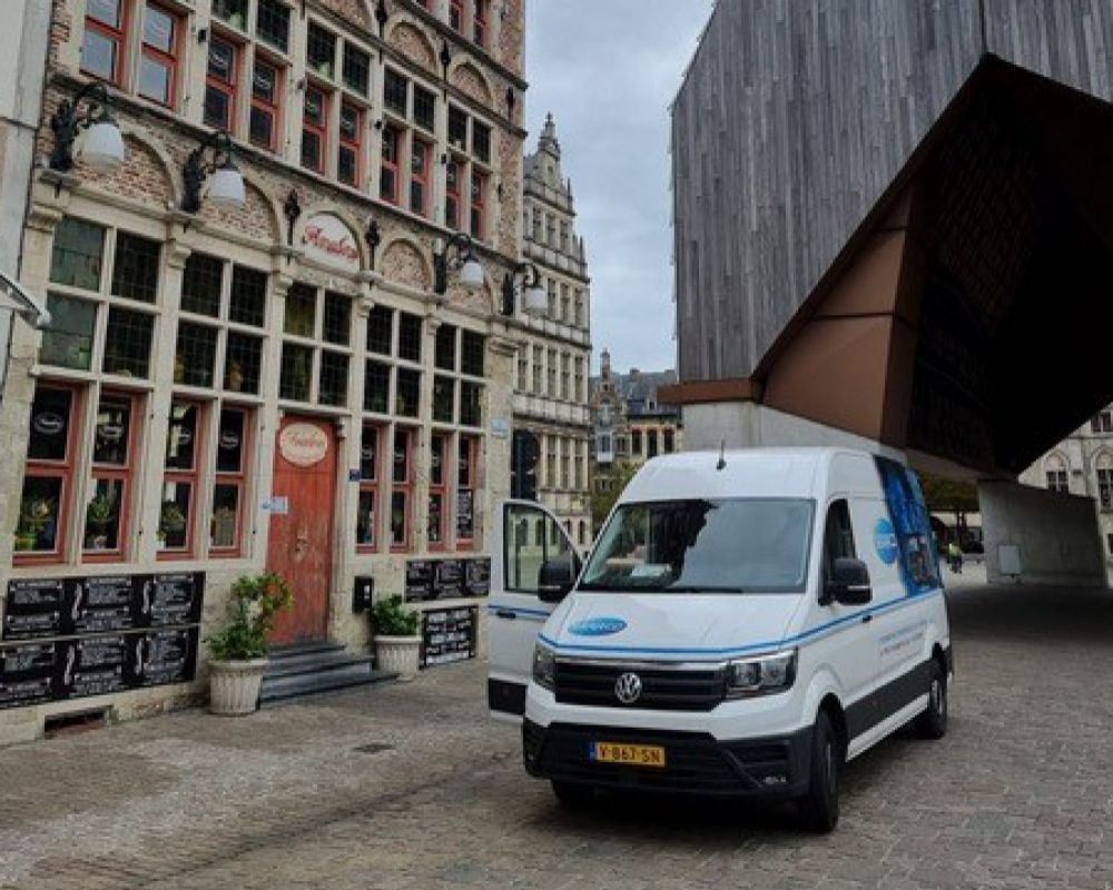Serrco van in front of a bar in a old town district