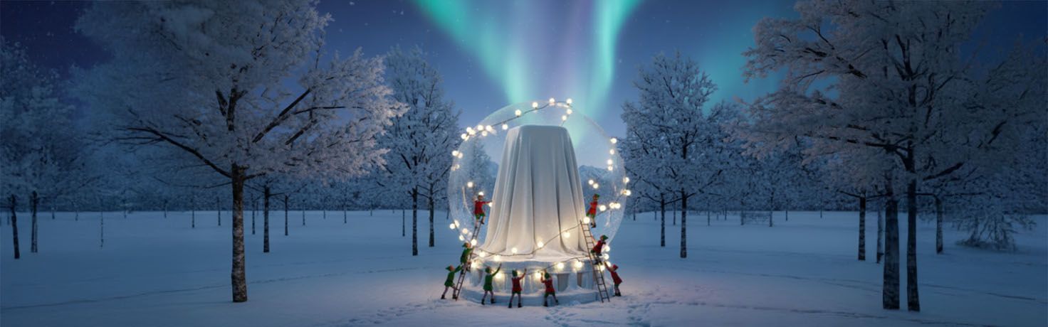 Image of big present hidden under a white blanket in a snow landscape